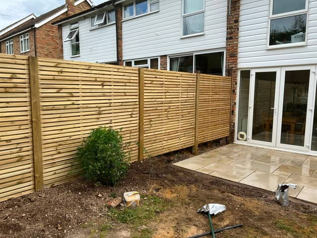 New slatted fence panels beside a patio
